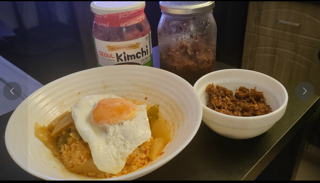 Homemade meal with rice, egg, kimchi, and side dish.